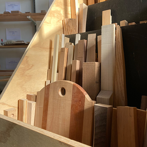 Wood boards standing upright in a woodworking shop.