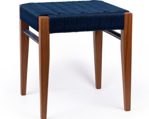 An upholstered stool with wooden legs.