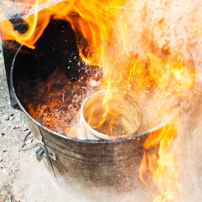 Raku-fired pottery in an open flame.