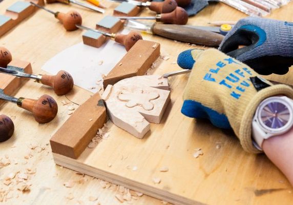 Wood carving tools and unfinished wooden ornaments.